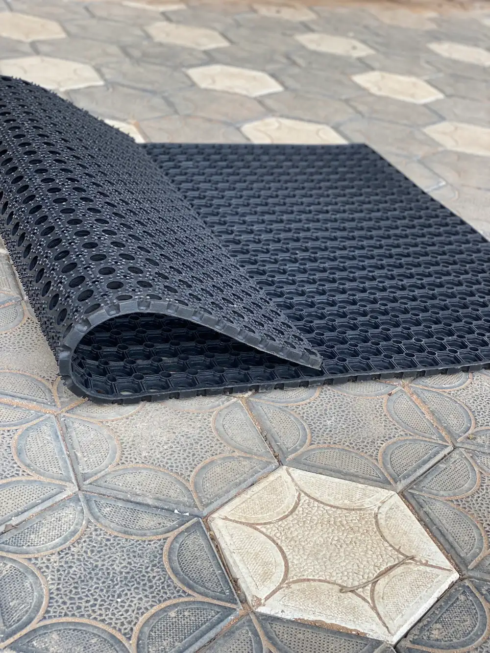 Rubber ring mat corner lifted to show the bevelled edge and thickness